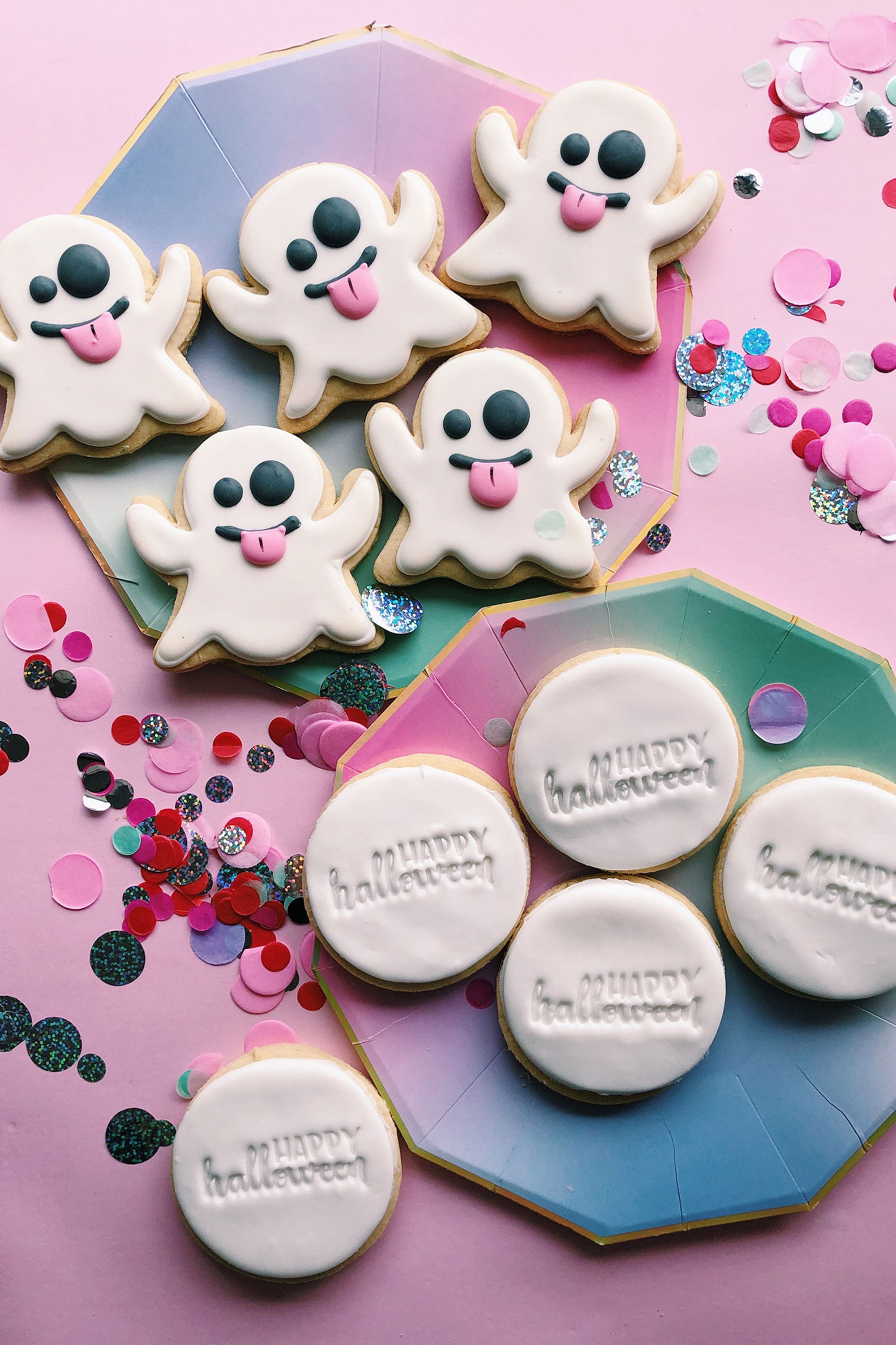 Halloween-themed cookies with ghost designs and 'Happy Halloween' text on a colorful background.