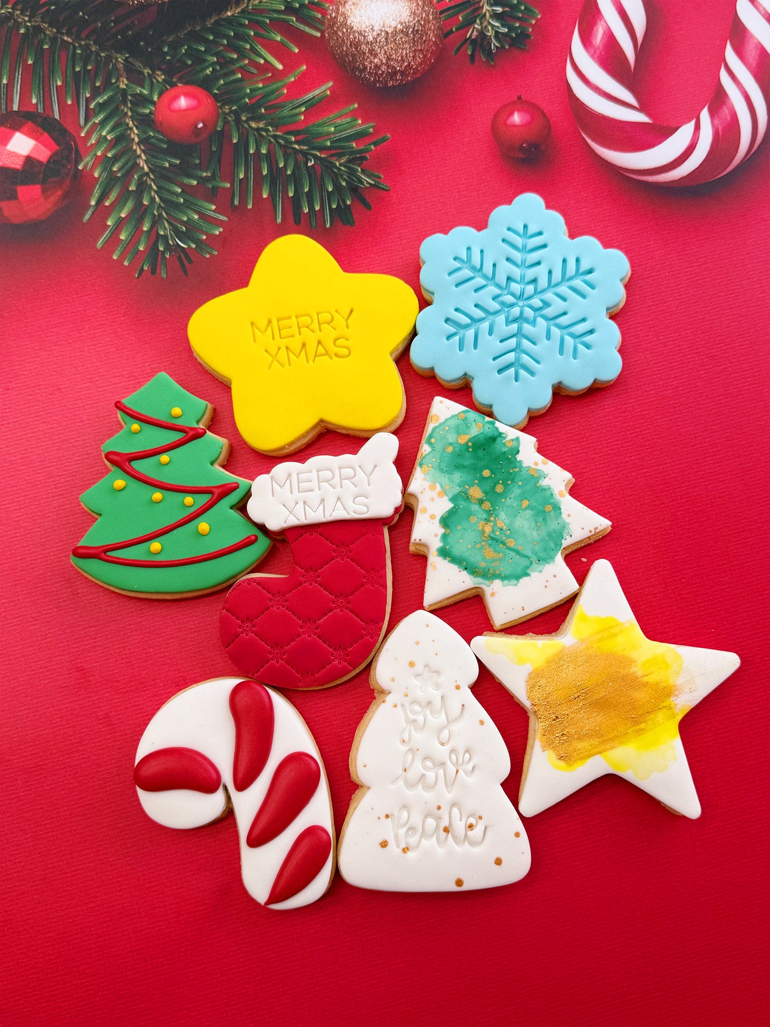 Decorative Christmas cookies with festive designs on a red background | Jolly Christmas Cookies | Personalised Christmas Cookie Box Delivery - Sugar Rush by Steph